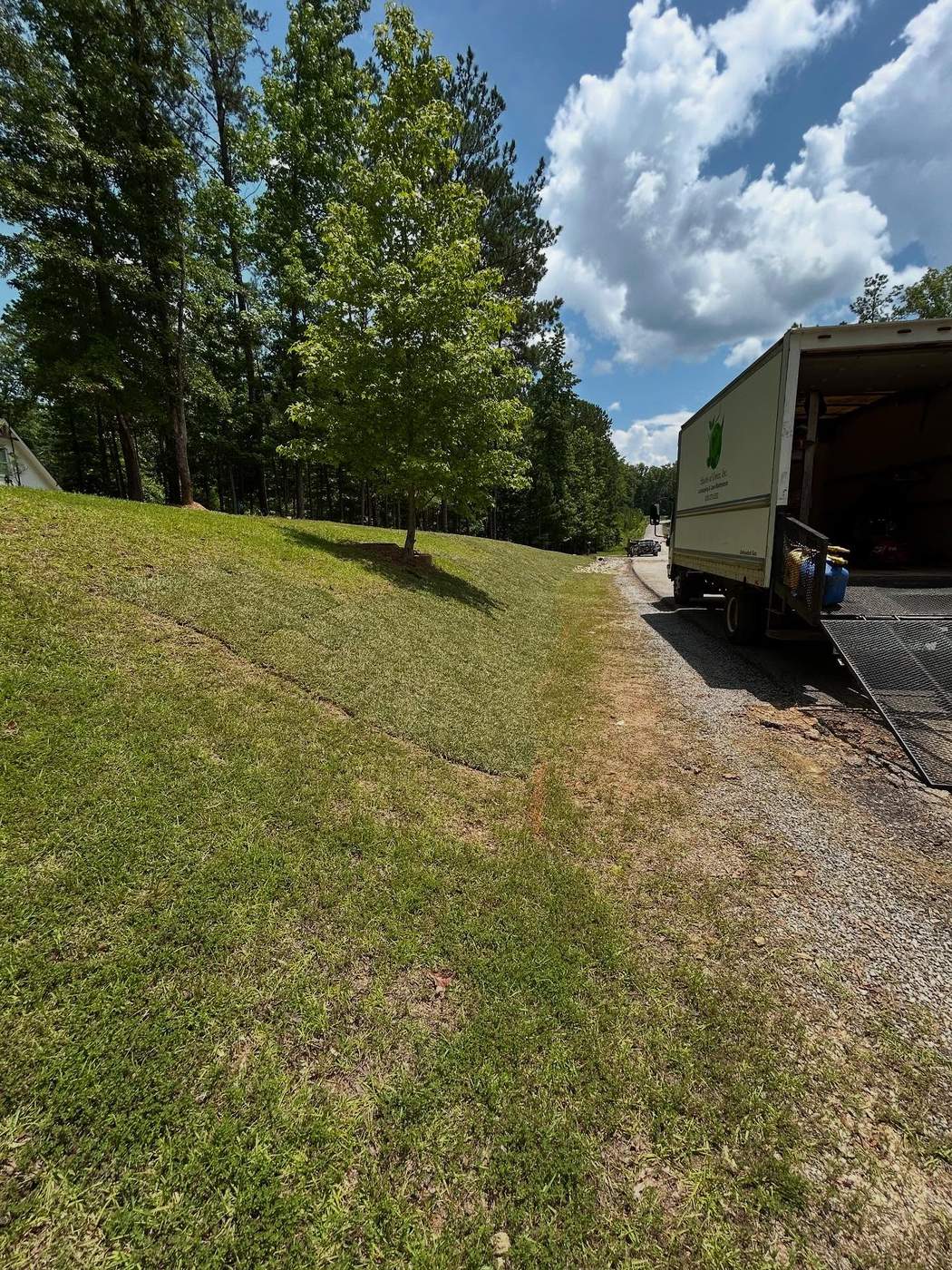 Skid steer grading work on a hillside property, Birmingham AL